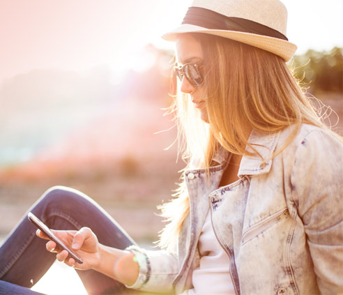 woman Using Fongo on cellphone outdoors. woman Using Fongo on cellphone outdoors.